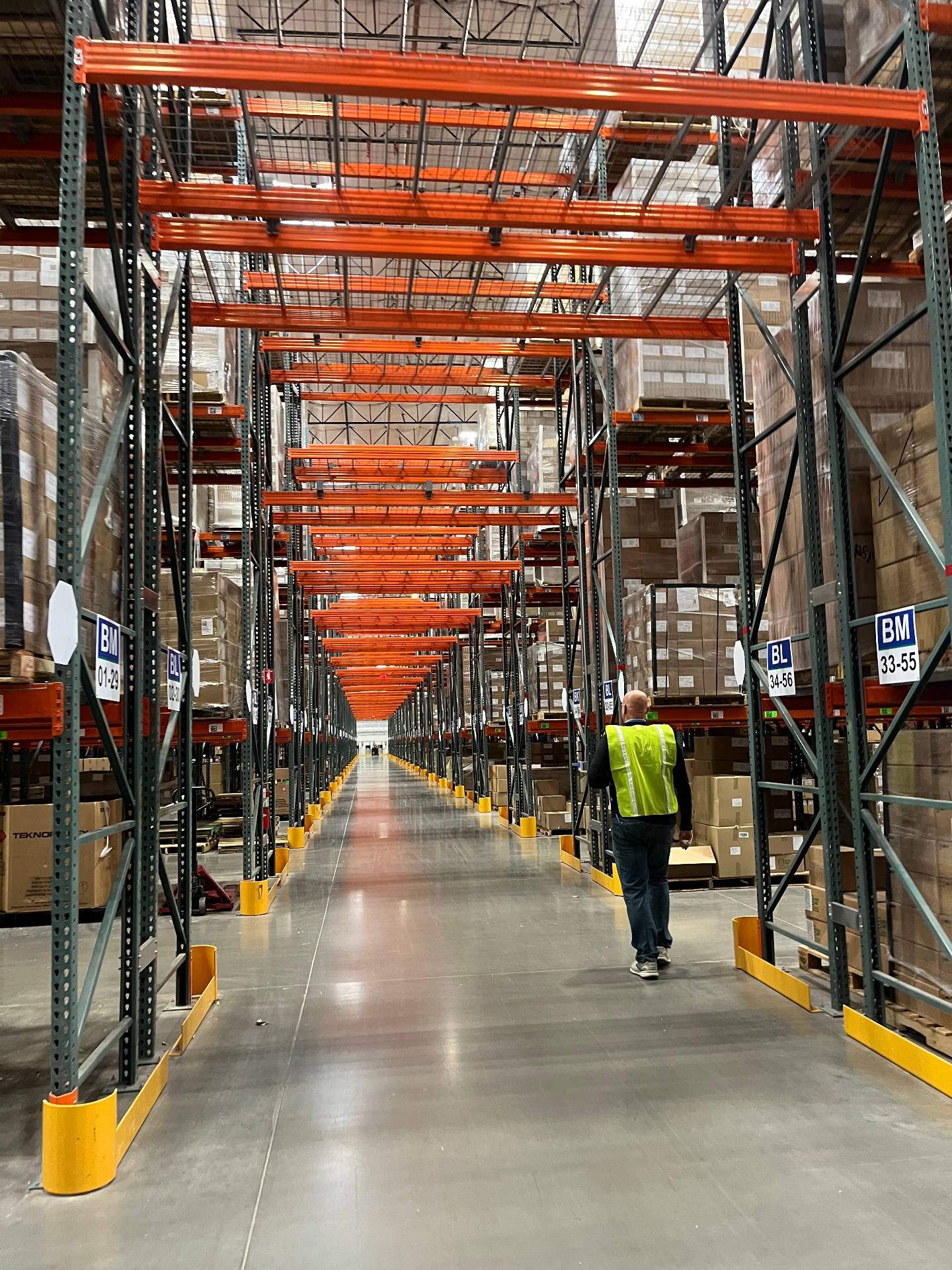 Warehouse aisle with orange pallet racking systems